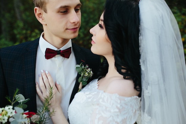 Romantic young newlywed couple in forest