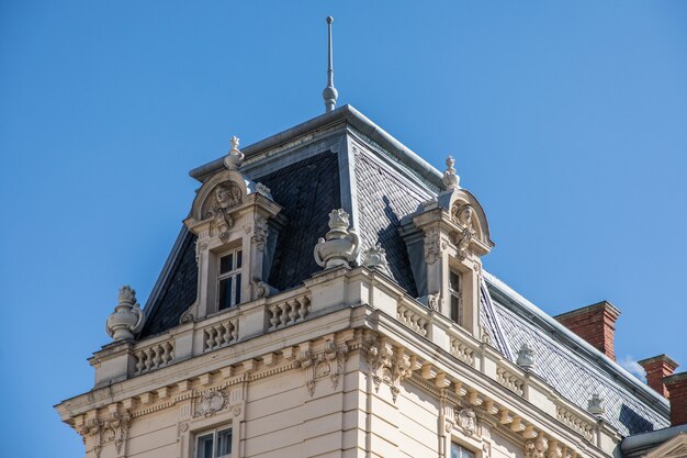 Roof of old building in front of blue sky in day time