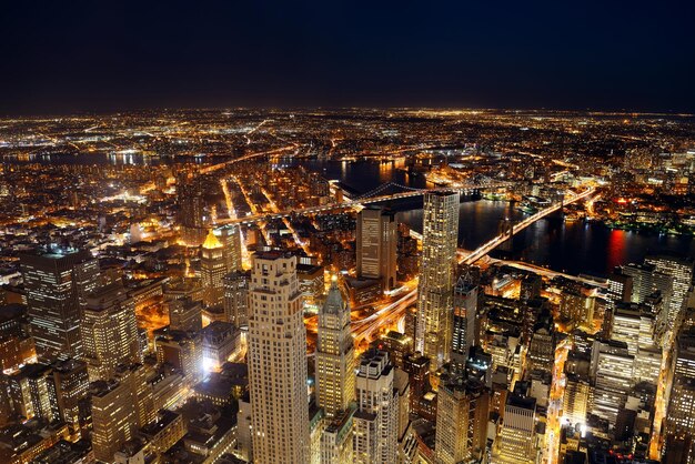 Rooftop night view of New York City downtown with urban skyscrapers