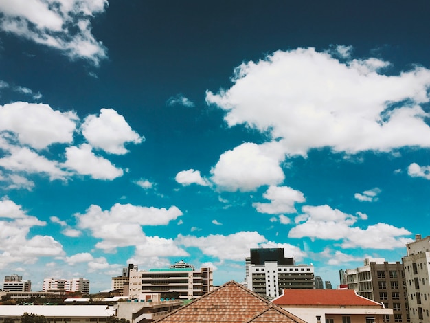 Free photo rooftops and blue sky with clouds