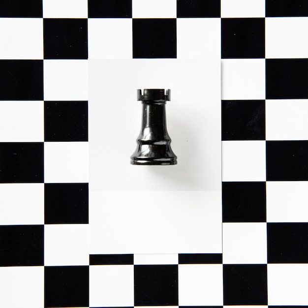 Free photo rook chess piece on a pattern