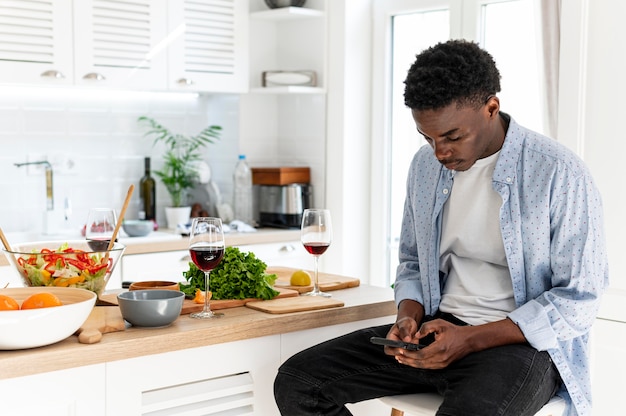 Free photo roommates man holding smartphone