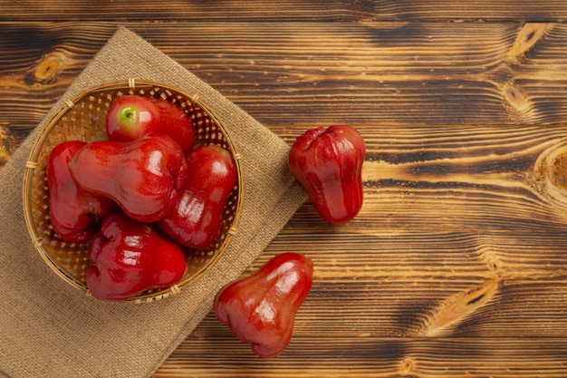 Rose apple on dark wooden surface