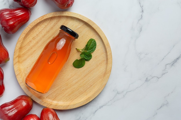 Free photo rose apple juice on white surface