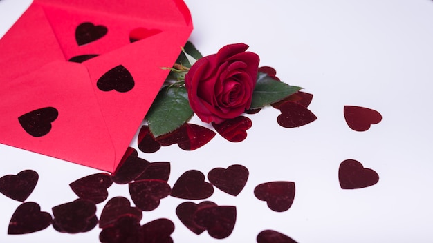 Free photo rose branch with small hearts on table