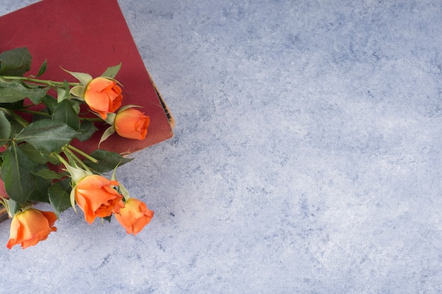 Rose bunch and shabby book on grunge table