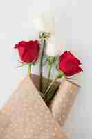 Free photo rose flowers in package paper on table