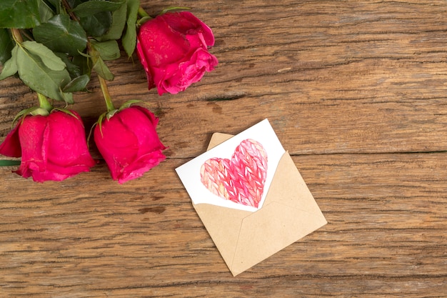Rose flowers with heart drawing in envelope