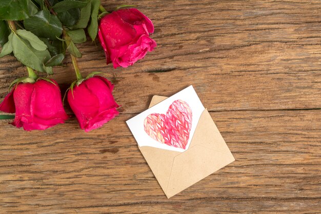 Rose flowers with heart drawing in envelope