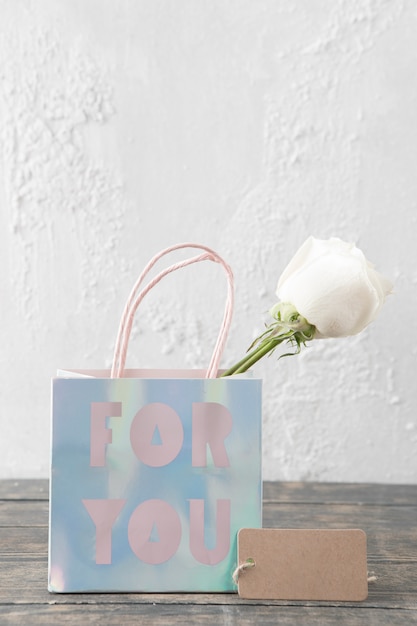 Rose in paper bag with For you inscription 