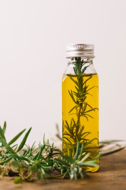Rosemary in olive oil bottle vertical shot