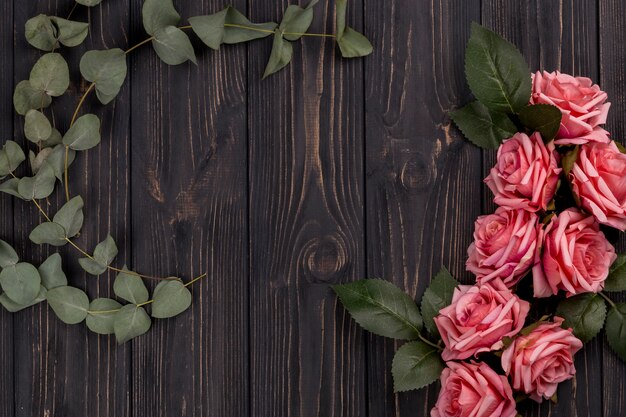 Roses and leaves on wooden tabletop