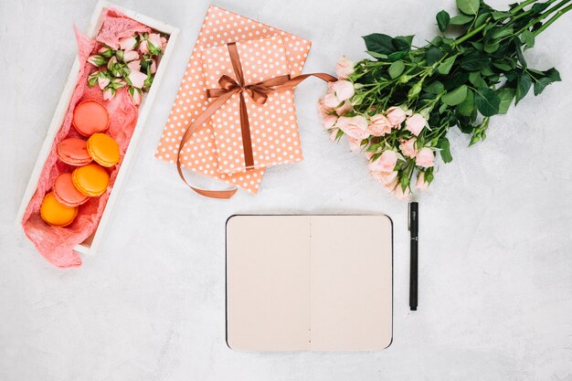 Roses near notebook and presents