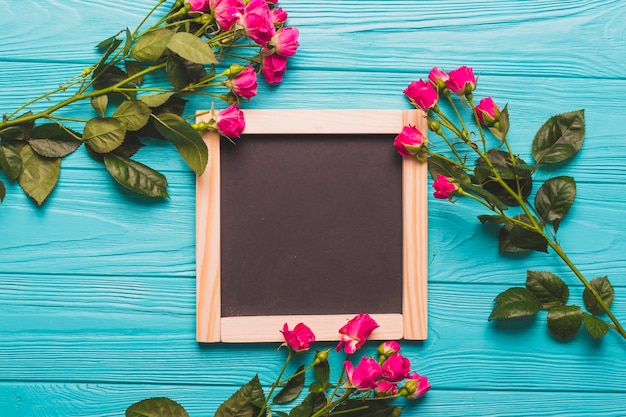 Roses near square chalkboard