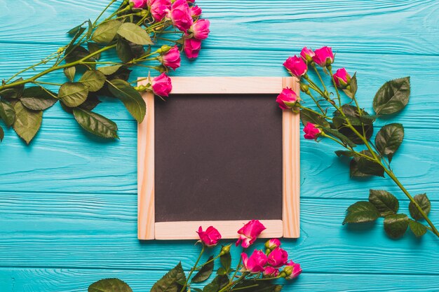 Roses near square chalkboard