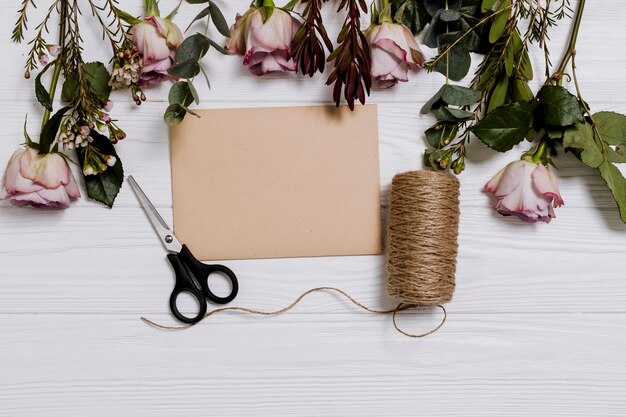 Roses and paper on table