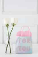 Free photo roses in vase with for you inscription on paper bag