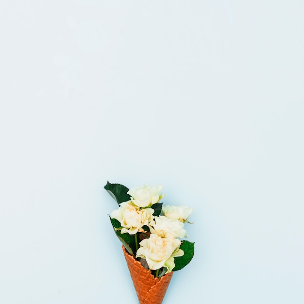 Free photo roses in waffle cone on table