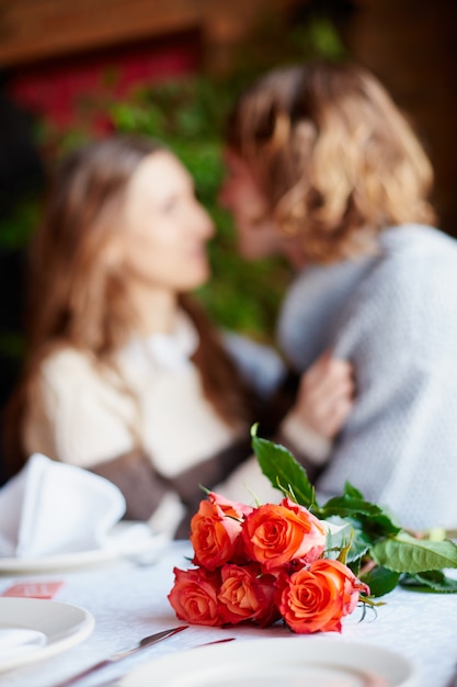 Free photo roses with couple blurred background