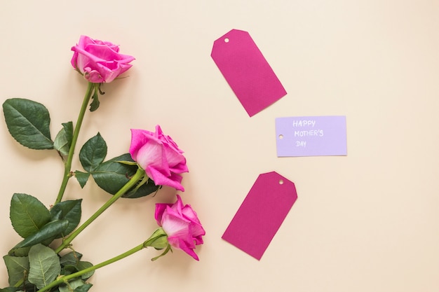 Roses with Happy Mothers Day inscription on table