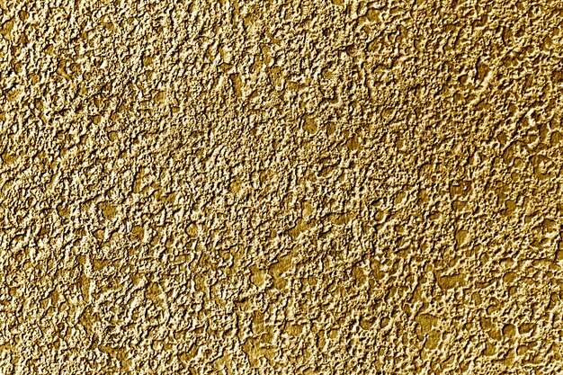 Roughly gold painted concrete wall surface background