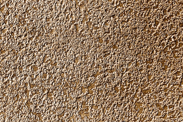 Roughly gold painted concrete wall surface background