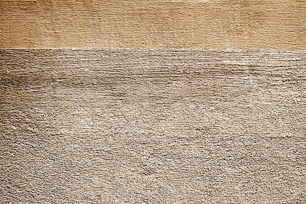 Roughly gold painted concrete wall surface