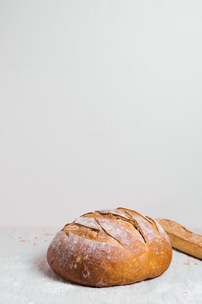 Free photo round baked bread with white copy space background