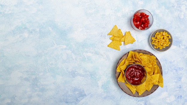 Round bowls with nachos sauce corn tomatoes