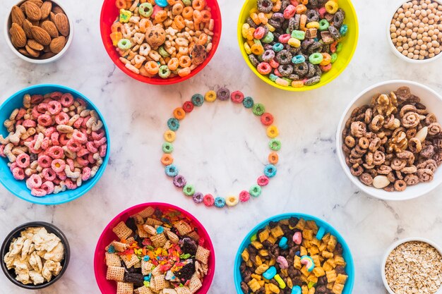 Round frame from bright cereals with bowls on table