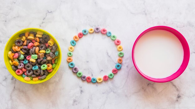 Round frame from cereals with bright bowls on table