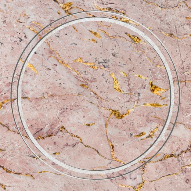 Круглая рамка на текстурированном фоне из розового мрамора Premium Фотографии