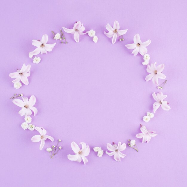 Round frame of small flowers on table