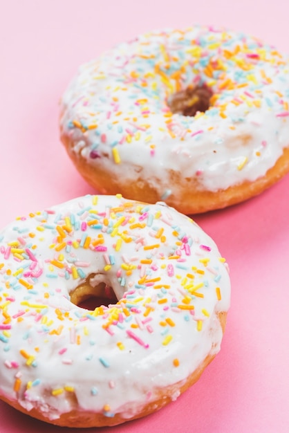 Round iced doughnuts topping with colorful decoration