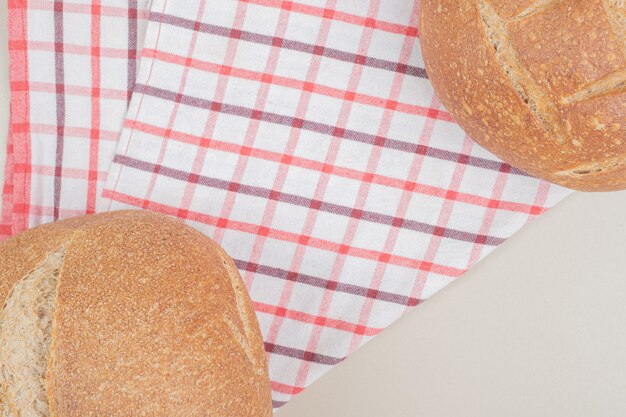 Round loaf of bread on tablecloth