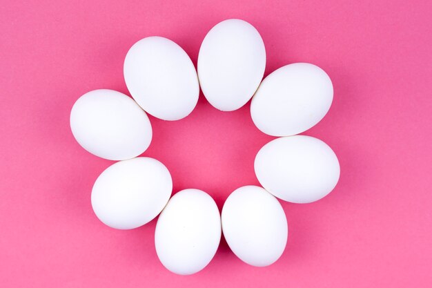 Round made from white eggs on table