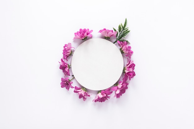 Round paper on purple flowers on table