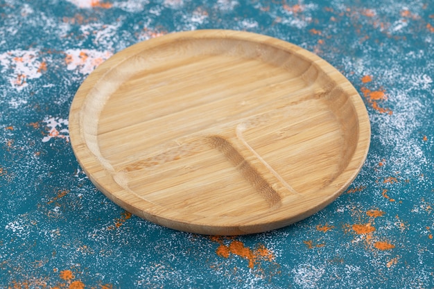 Round snack platter with carved pieces in it. 