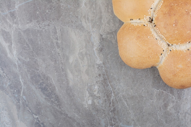 A round white bread on marble surface