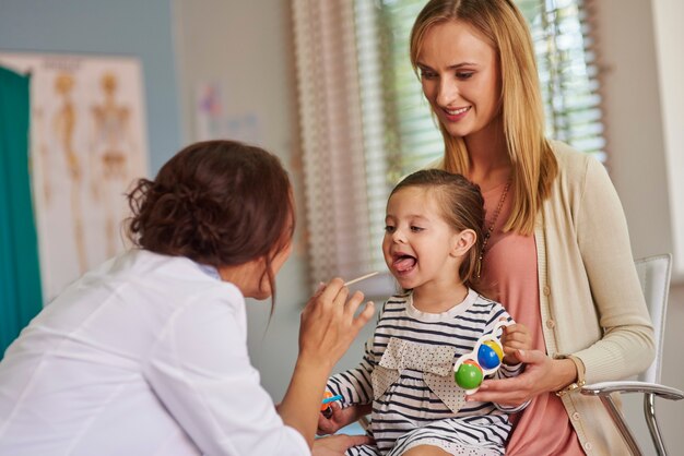 Routine examination of little girl's throat