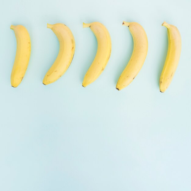 Row of bananas on blue