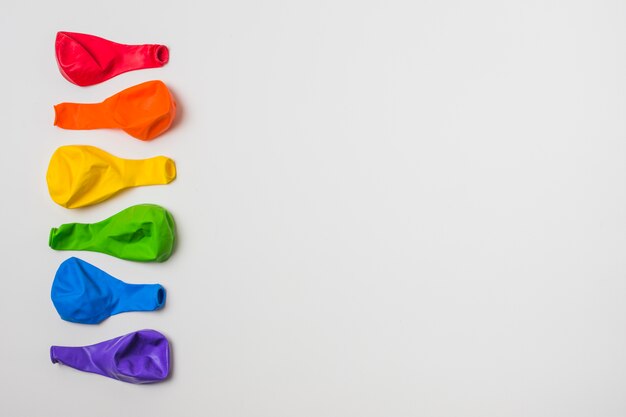 Row of bright balloons in LGBT colors