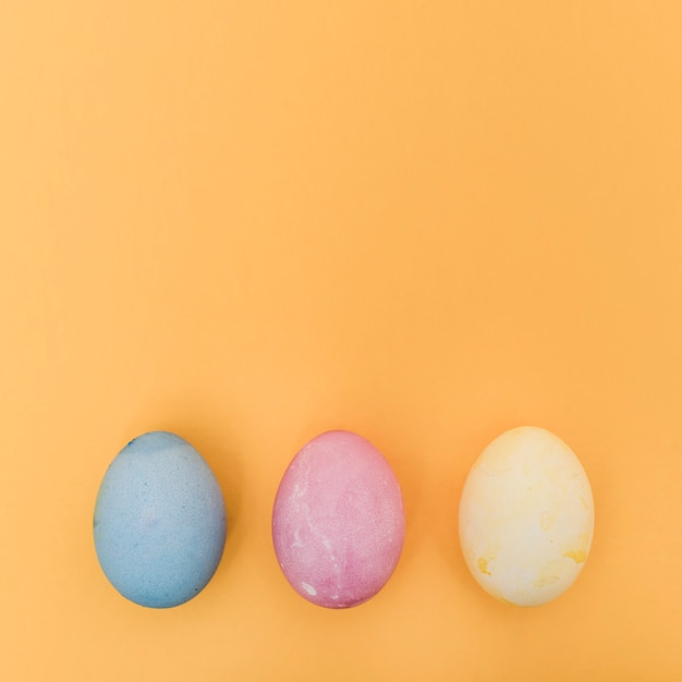 Row of colorful Easter eggs on table