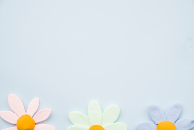 Free photo row of colorful flower clay on gray background