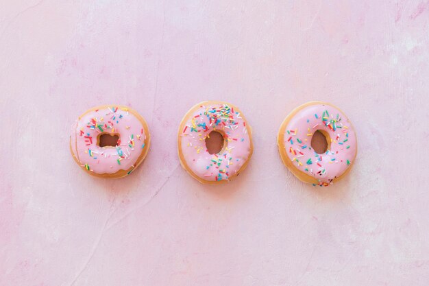 Row of colorful pink donuts