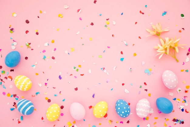 Row of Easter eggs between bright confetti