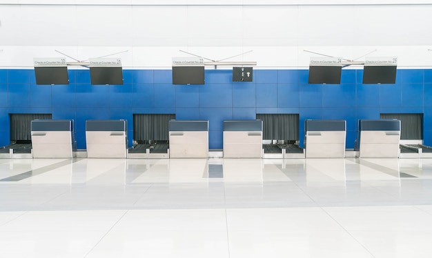 row empty check-in desks in international airport