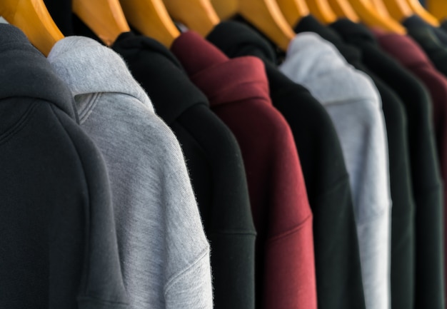 Row of Fashionable clothing on hangers .