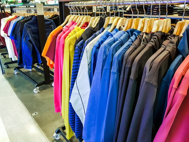 Row of Fashionable clothing on hangers .