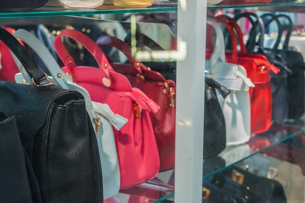 Row of Ladies leather handbags .